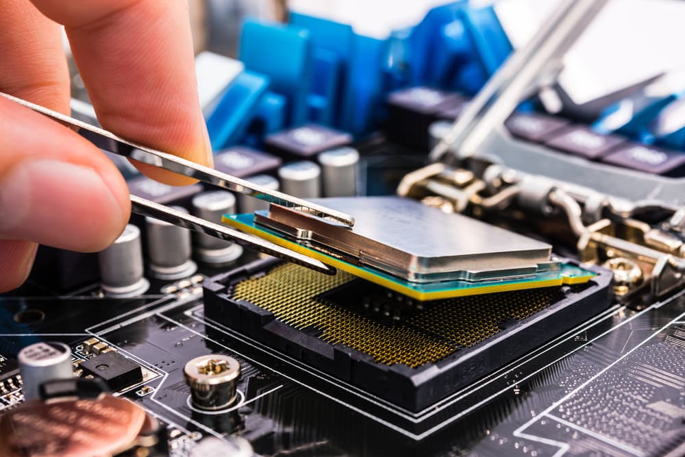 Modern processor and motherboard for is bein repaired by an expert.
