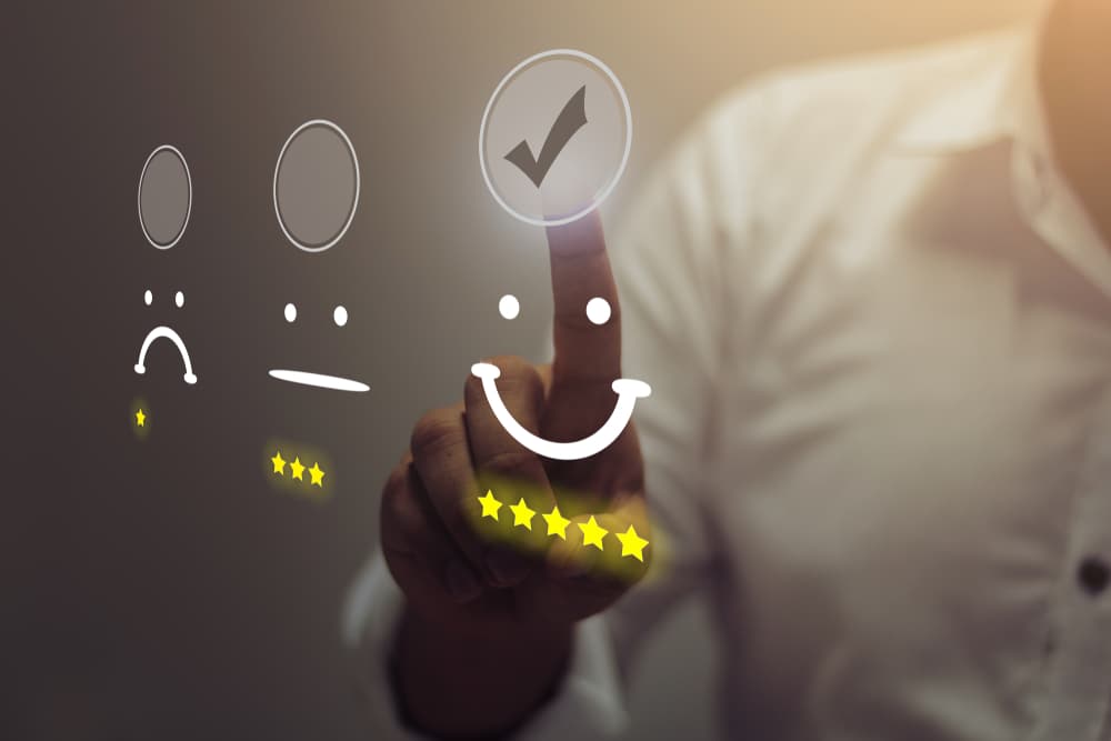 Professional pressing a smiley face emoticon on a virtual touch screen, illustrating the concept of customer service evaluation.